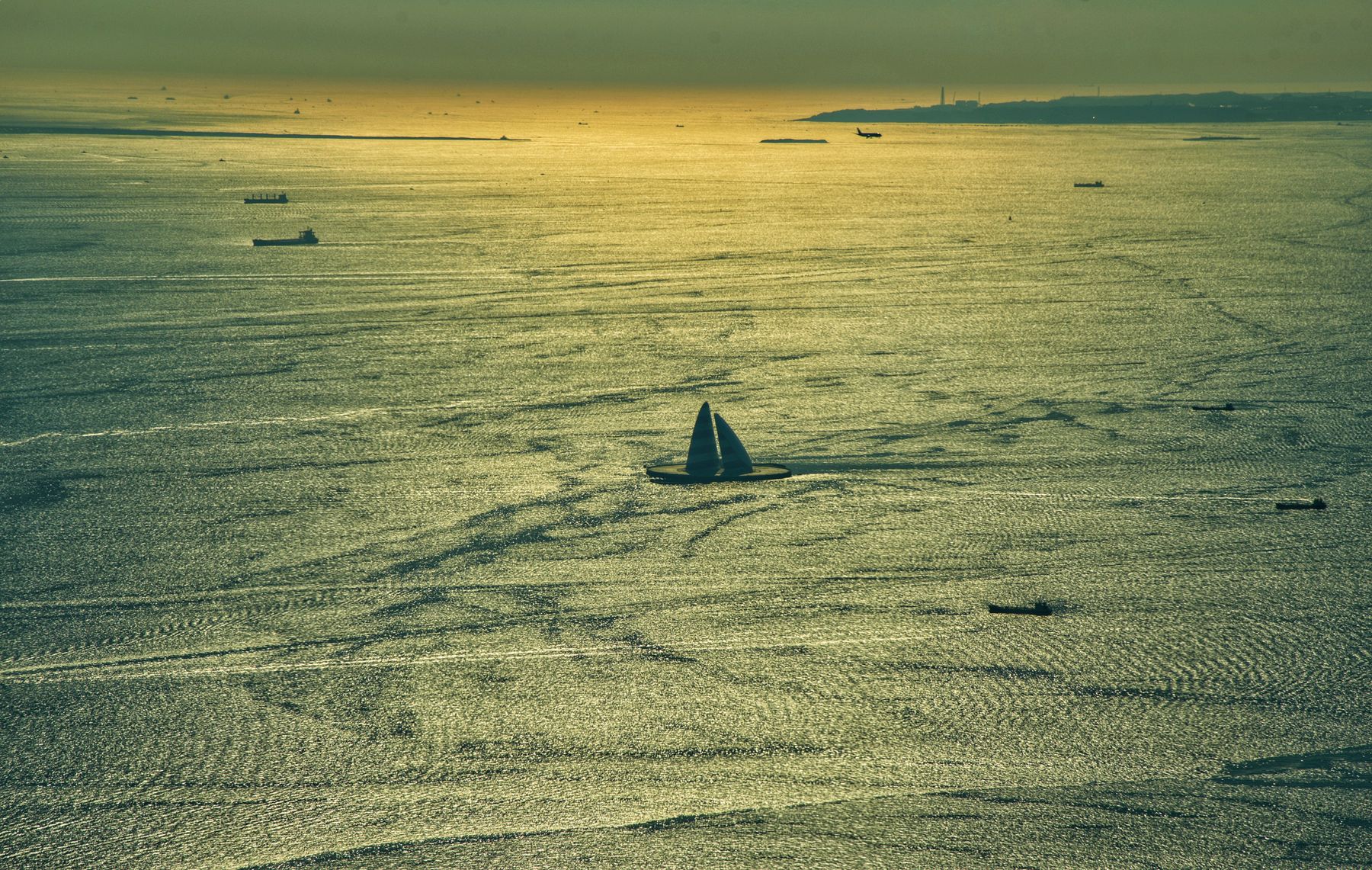 Aerial view of a boat on open water in golden light