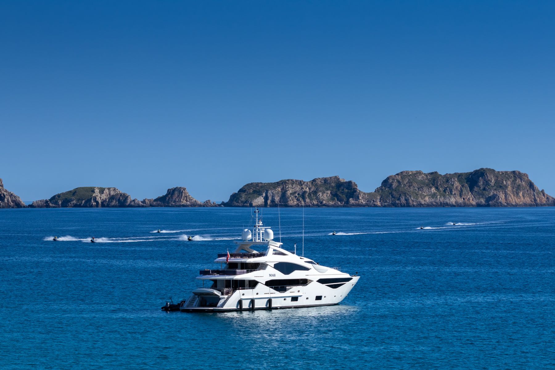 Meridian, a white sport yacht at anchor in deep blue water